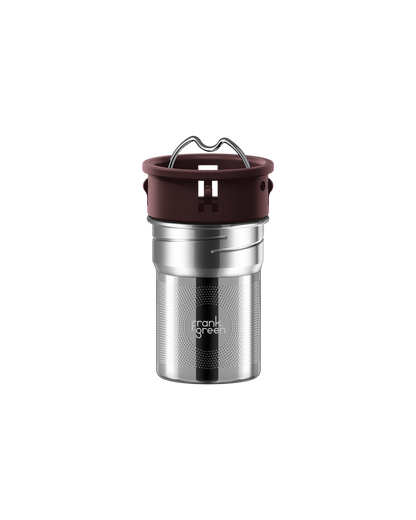 A stainless steel travel tumbler with a dark brown silicone lid and a metal carrying loop, featuring the 'frank grill' logo on the front, set against a plain white background.