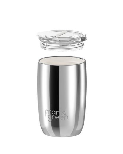 A stainless steel travel tumbler with a clear lid, shown with the lid floating above the cup on a plain white background. The brand name 'frank green' is printed near the bottom.