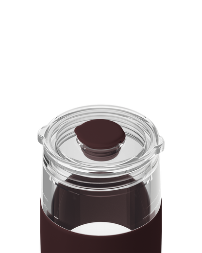 Close-up of a clear glass bottle with a dark brown silicone sleeve and a matching dark brown lid, shown on a white background.