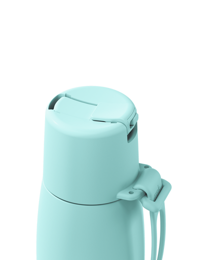 Close-up of a light mint green insulated bottle lid with a carrying loop, shown on a solid white background.