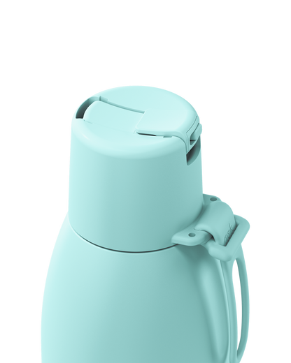 A close-up of a light mint green insulated bottle showing the lid and handle against a solid white background.